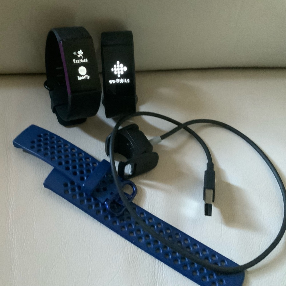 Fitbit Charge 4 Tracker lots of 2 with one charger and extra band. Works great.